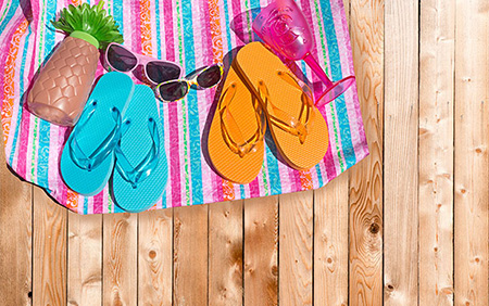 Flip-flops and sunglasses on a beach towel