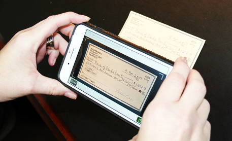 Smartphone taking a picture of a check for mobile deposit